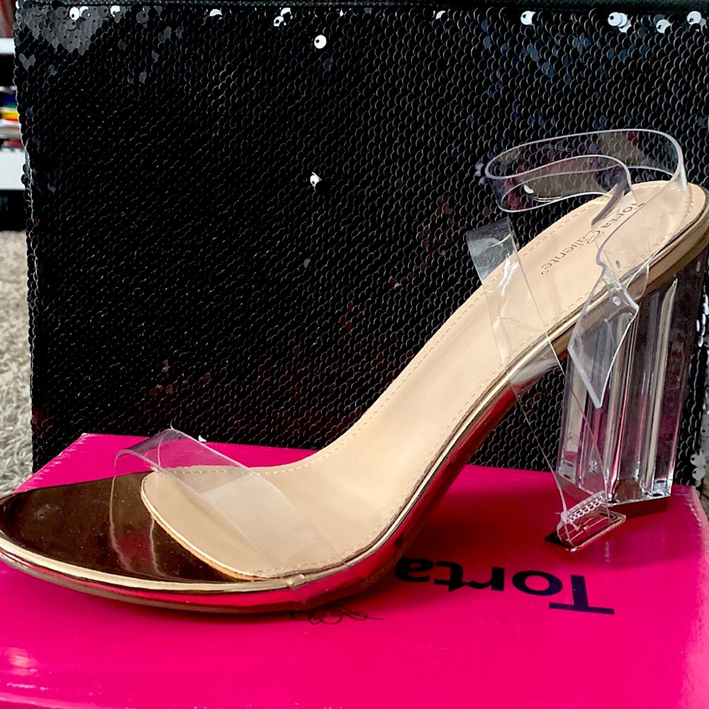 Torta Caliente clear heels with rose gold base. Size 12 but fits like an 11